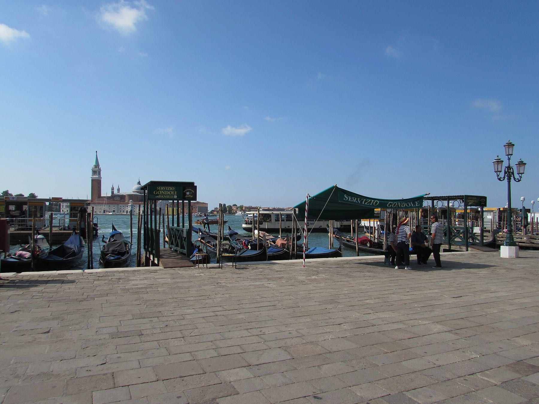 Gondolas tied up along the Riva degli Schiavoni in front of Venetian facades