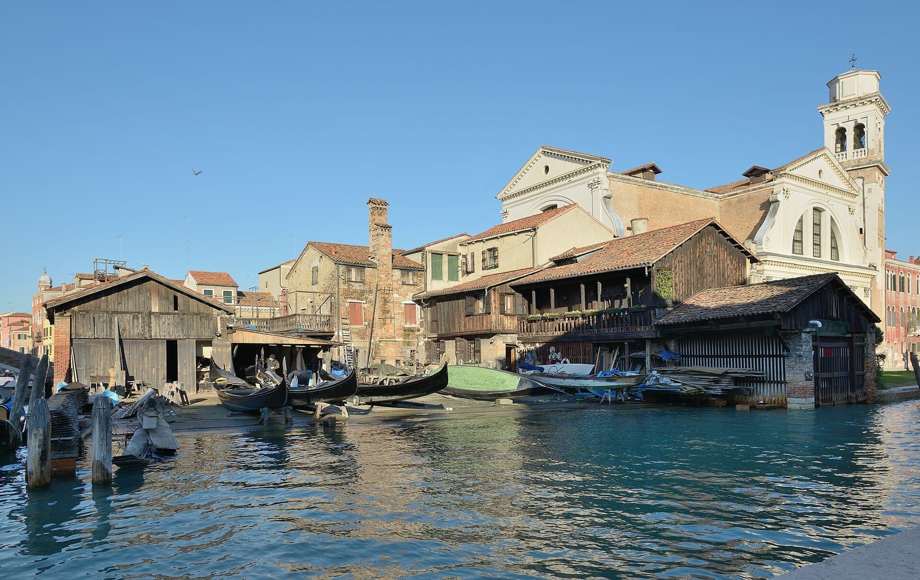Gondolas hauled out for repair at the Squero di San Trovaso boatyard, seen across the canal from Fondamenta Nani